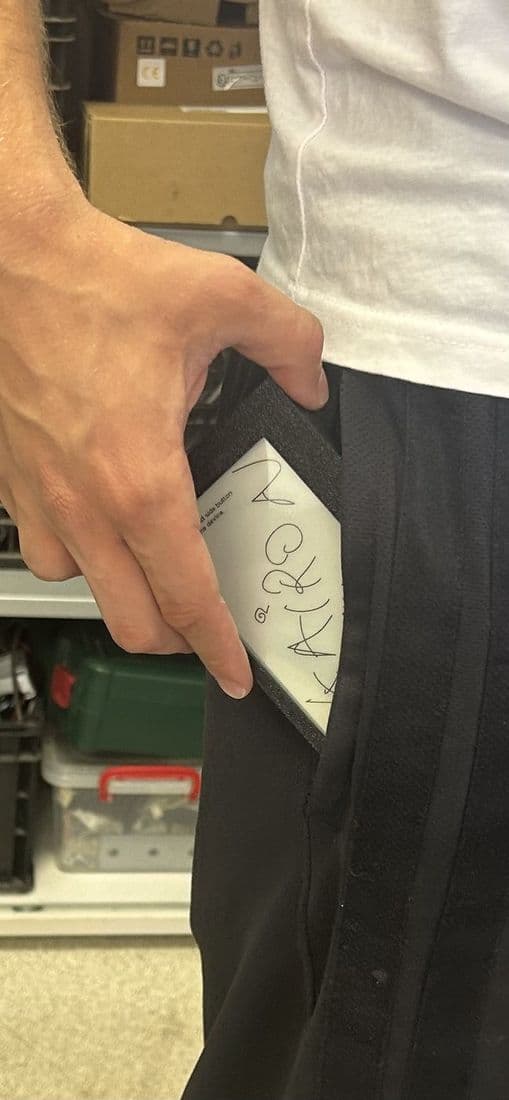 Kairon sliding into a trouser pocket